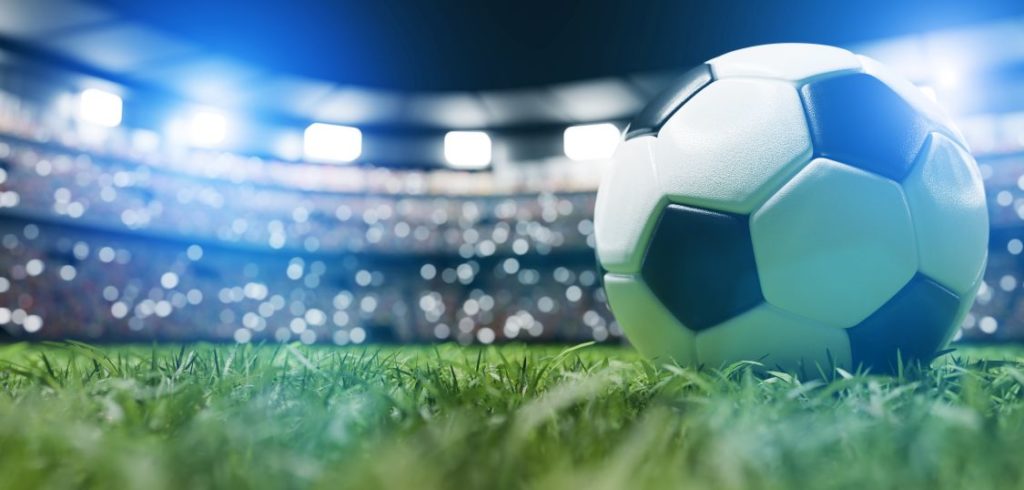 Football soccer ball on grass field on stadium Football soccer ball on grass field on stadium, evening match.