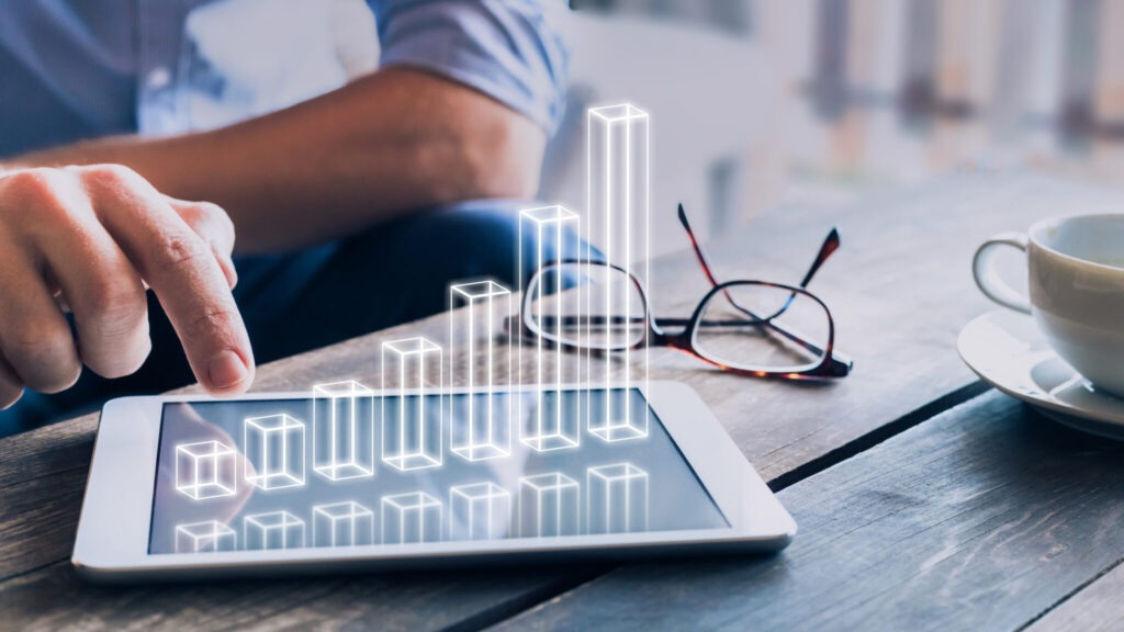 Businessman analyzing growing 3D AR chart floating above digital tablet computer screen, showing successful increase in business profit